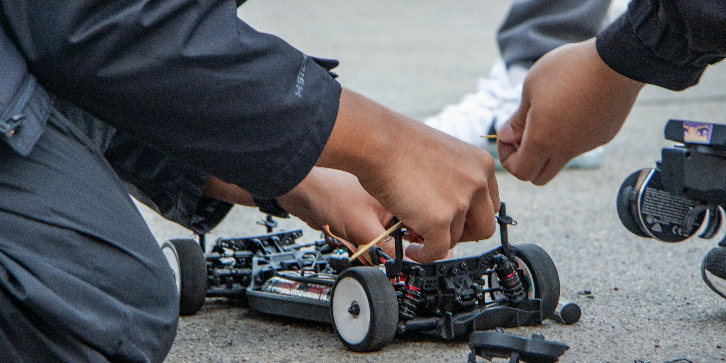 GT Racing members resetting a chassis together between December 2025 test runs
