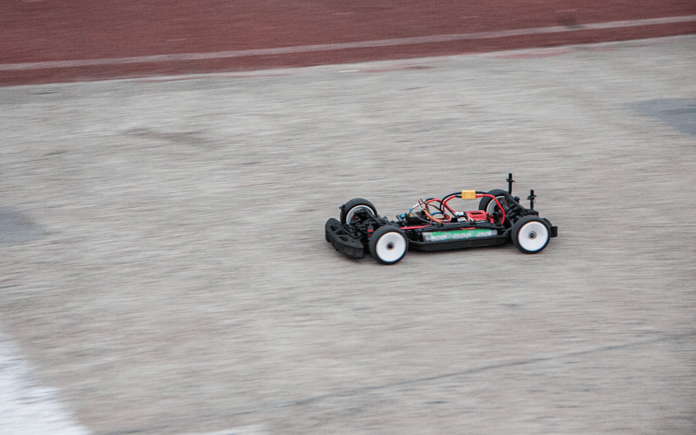 An uncowled GT Racing chassis moving through a December 2025 test run