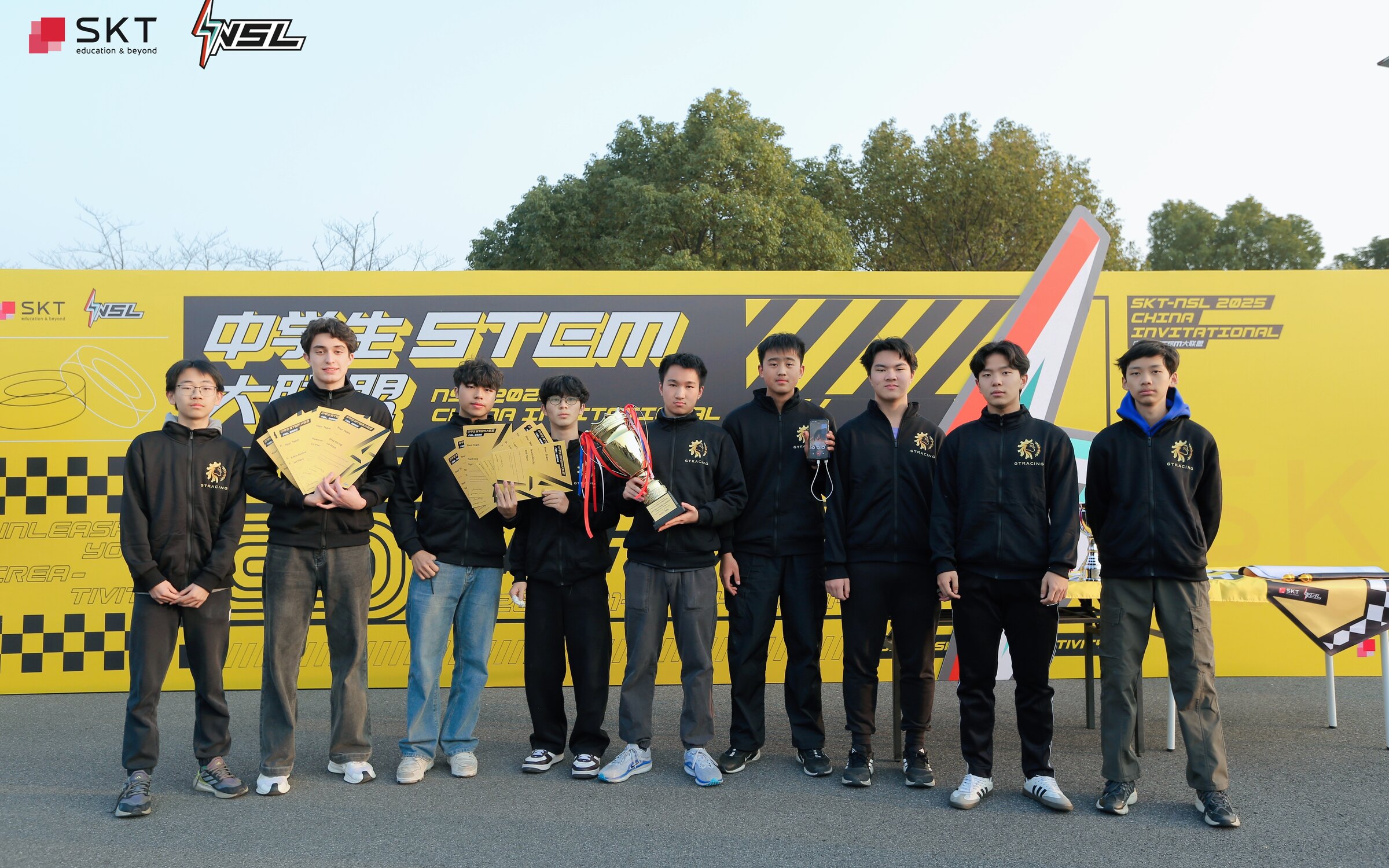 GT Racing members standing together with competition certificates and a championship trophy