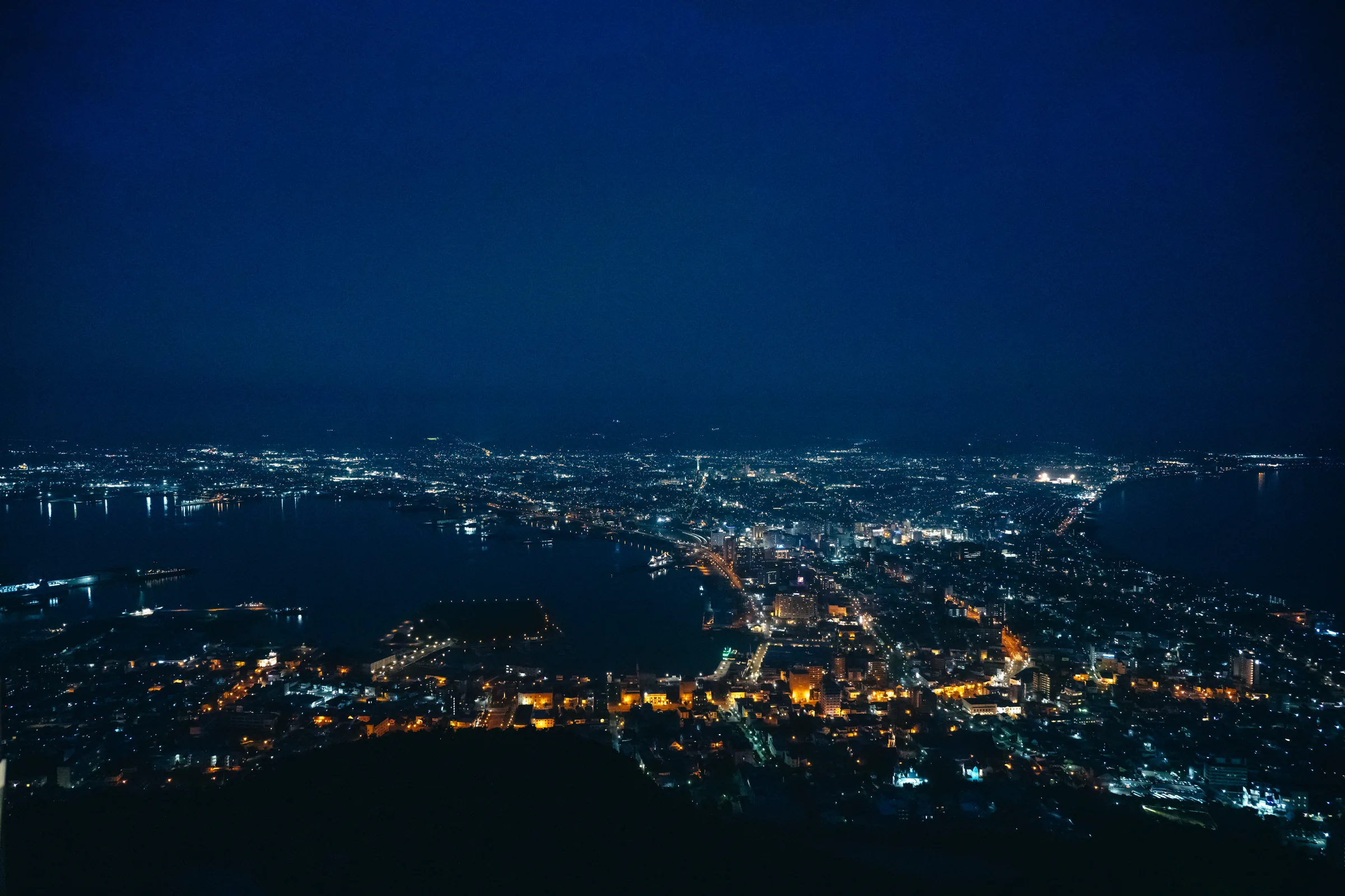 Hakodate's illuminated city and twin bays seen at night from Mount Hakodate