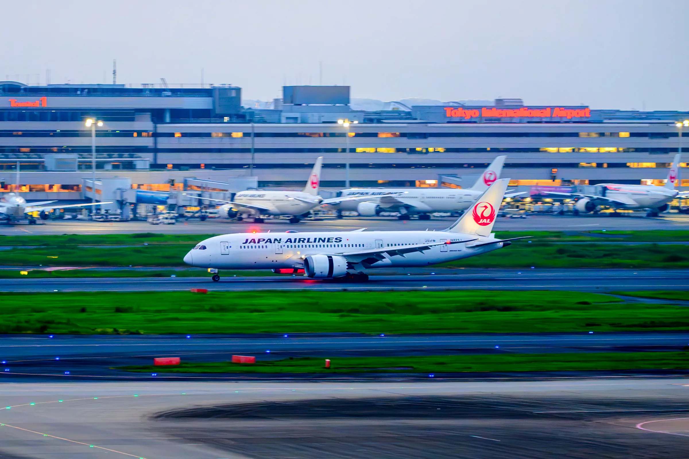 A Japan Airlines aircraft photographed with a panning motion across the runway