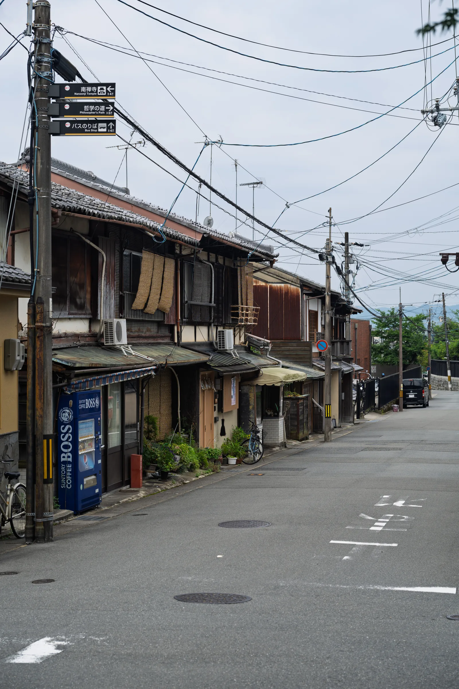 An empty residential street near Nanzen-ji beneath a web of utility lines