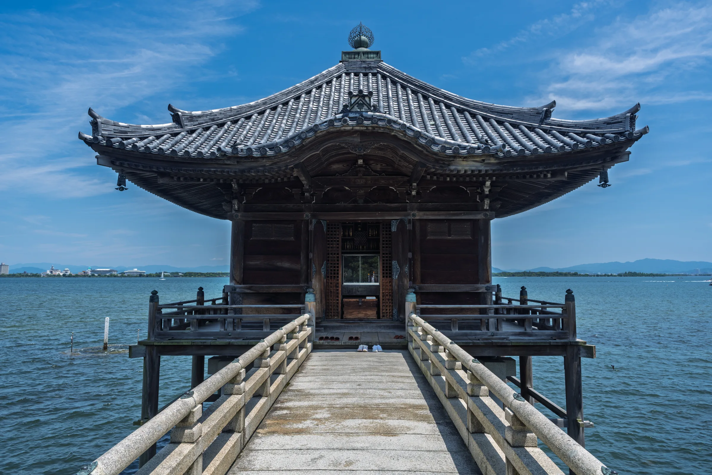 Ukimido hall standing at the end of a narrow bridge over Lake Biwa