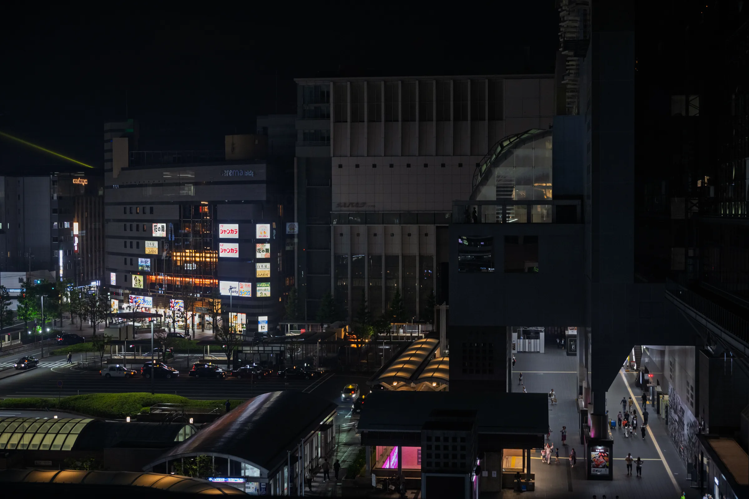 Kyoto's streets and illuminated buildings seen at night from the station